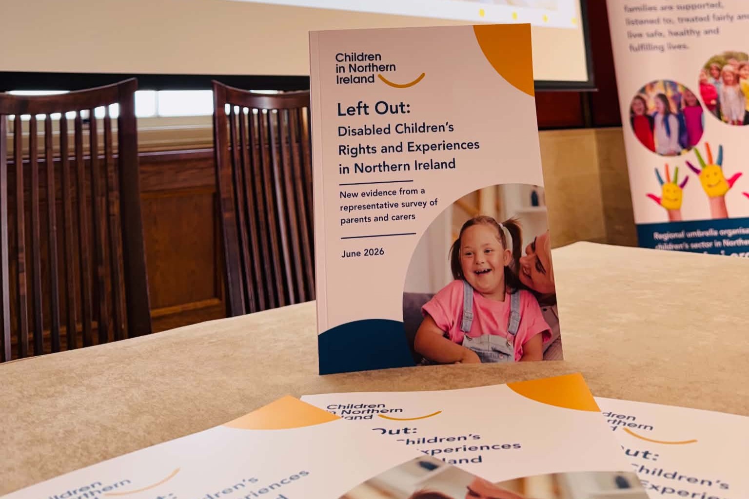 Left Out research reports sitting on table at the launch event at Parliament Buildings Stormont