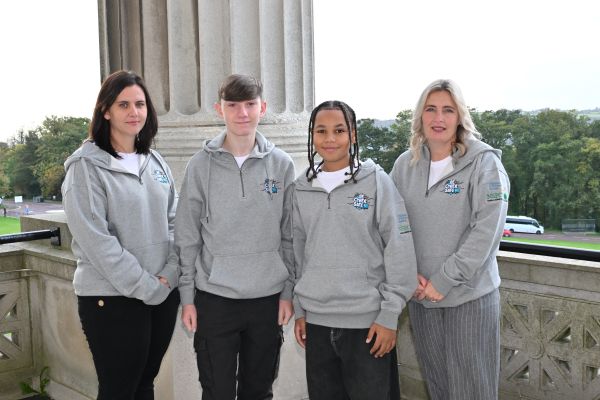 This photo shows young people from Black Mountain Action Group who are members of Be Cyber Safe NI. They are photographed with their Youth Leaders from Black Mountain Action Group. They are standing on the balcony at Parliament Buildings Stormont. This photo was taken at the Cyber Cafe event. 